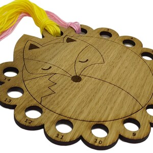 Curled up fox thread holder with 14 holes for thread