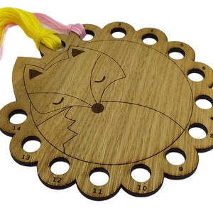 Curled up fox thread holder with 14 holes for thread