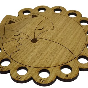 Curled up fox thread holder with 14 holes for thread
