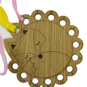 Curled up fox thread holder with 14 holes for thread