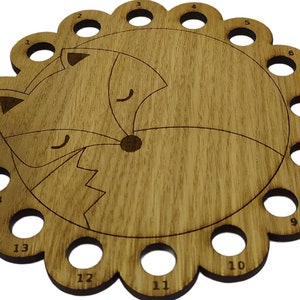 Curled up fox thread holder with 14 holes for thread