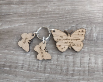May include: Wooden butterfly keychain with the text "My favourite people call me NANNY" and two smaller butterflies with the names "Emily" and "Bethany" engraved on them.