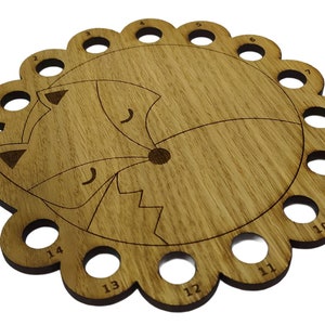 Curled up fox thread holder with 14 holes for thread