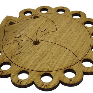 Curled up fox thread holder with 14 holes for thread