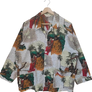 May include: A patterned button-down shirt with a tropical design. The shirt features figures in traditional dress, palm trees, and boats. The main colour is white, with a beige and brown map-like background, and red, green, and orange accents.