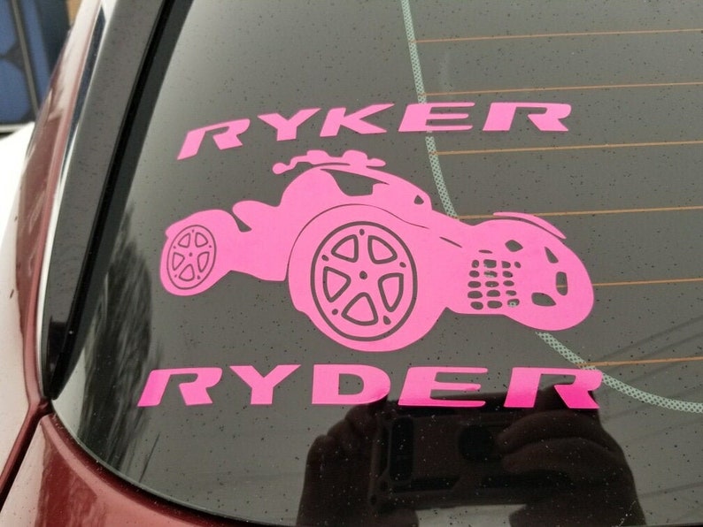 May include: Pink vinyl decal with the names Ryker and Ryder and a silhouette of a three-wheeled vehicle.
