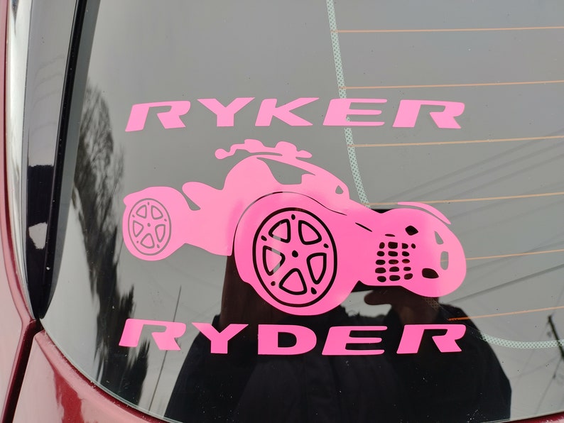 May include: Pink vinyl decal with the name "Ryker Ryder" and a silhouette of a three-wheeled vehicle.