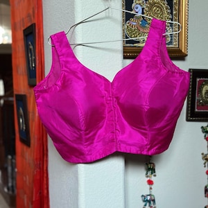Hot pink sleeveless silk padded blouse. Size  38. Has margin upto 42 inches