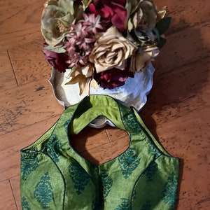 Green silk with handblock printed  halter blouse in black. Size  38. Has margin upto 42 inches