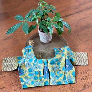 Yellow and copper sulphate floral kalamkari and  hand work  kantha stitch on pure tussar silk blouse. Size  38. Has margin upto 42 inches