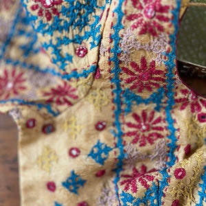 Hand kutch embroidery on light creamish yellow pure tussar silk. Blouse Size  38. Has margin upto 42 inches