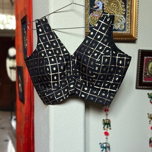 Black silk checkered sleeveless blouse in black. Size  38. Has margin upto 42 inches