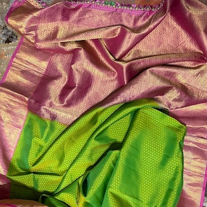 Parrot green with light pink bordered brocade kanchipuram silk saree. Tailored blouse size 38 with margin to 42