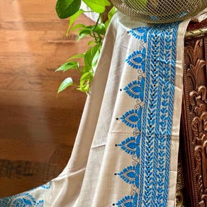 Cream tussar silk saree with gorgeous blue hand kantha stitch. Tailored blouse size 38