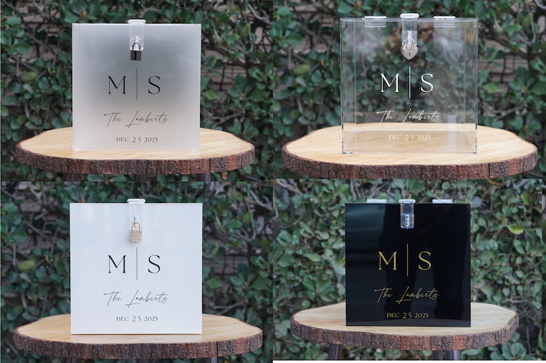 May include: Four acrylic wedding card boxes with different finishes. The boxes are clear, frosted, white, and black. Each box has a lock and key, and is decorated with the initials "M|S" and the text "The Lomberts" and "DEC 25 2025".
