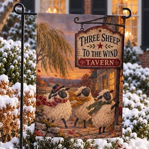 May include: A rectangular garden flag featuring an illustration of three fluffy sheep wearing colorful scarves and hats. The text reads Three Sheep To The Wind Tavern. The scene depicts a sunset landscape with a tree and a building in the background.