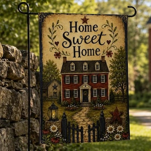 May include: A rectangular garden flag featuring a beige background with the text Home Sweet Home in black script. The design depicts a red two-story house with a stone path, a black fence, a lantern, and floral accents, all suspended on a metal stand.