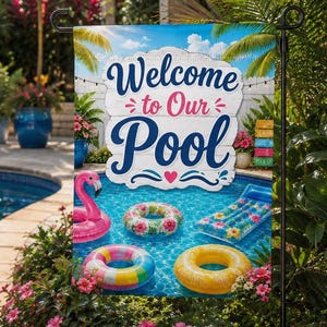 May include: A rectangular garden flag featuring the text Welcome to Our Pool in blue and pink script. The design displays a swimming pool with a pink flamingo float, a floral ring, a striped ring, a yellow ring, and a blue patterned pool float.