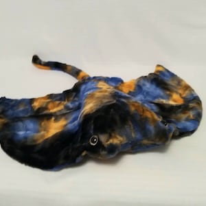 May include: A blue, black, and orange plush stingray toy with black eyes.