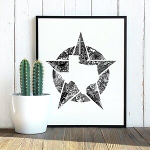 May include: A black framed print featuring a detailed black and white illustration of the state of Texas within a star shape. The artwork is set against a white background. A potted cactus is to the left of the print.