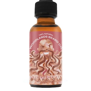May include: A brown glass bottle with a dropper top. The label is pink and features a cartoon illustration of a bearded man with the text "100% NATURAL WOODLANDS BEARD CO. LOVE POTION #14 BEARD OIL NET 1 FL. OZ (30ML)"