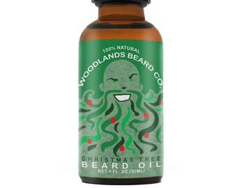 May include: A brown glass bottle with a dropper top. The label is green and features a cartoon illustration of a bearded man with a Christmas tree beard. The label reads "100% Natural Woodlands Beard Co. Christmas Tree Beard Oil Net 1 fl. oz (30ml)"