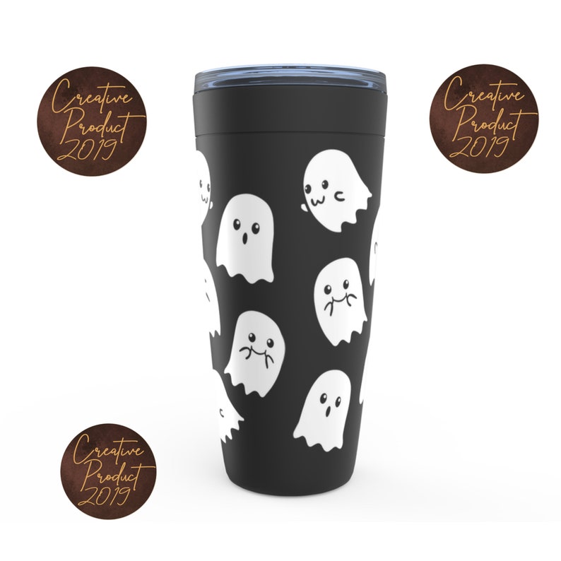 May include: Black travel mug with a white ghost pattern. The ghosts have different facial expressions. The mug has a black lid with a silver band.
