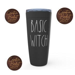 May include: Black travel mug with a white inscription that reads "BASIC WITCH".