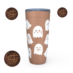 May include: A brown travel mug with a white ghost pattern. The ghosts have different facial expressions. The mug has a lid.