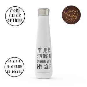 May include: A white insulated water bottle with a silver lid. The bottle has the text "MY JOB IS STARTING TO INTERFERE WITH MY GOLF" in black. Additional text includes "MORE COLOR OPTIONS" and "Creative Product 2019".