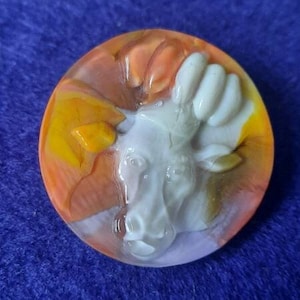 Button profile of cow on coloured glass. Large 3.5cm diameter.