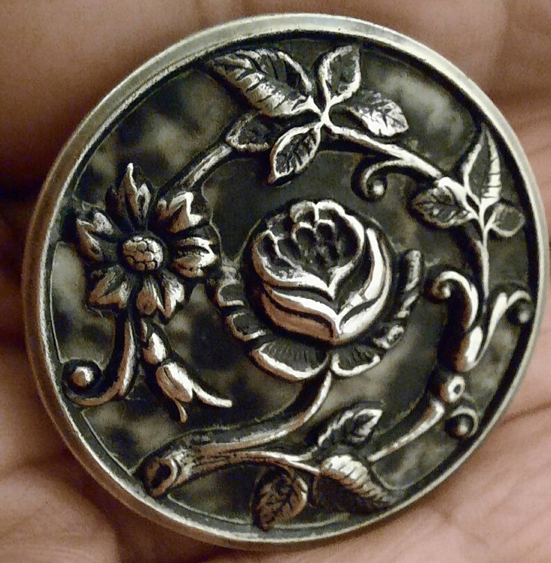 3.5cm. 1 repousse button,antique picture button,trailing rose design with black and white color backing