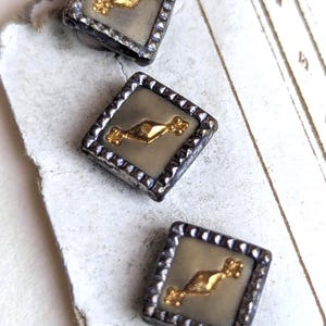 Juego de tres pequeños botones austriacos • Centros con efecto de acero tallado plateado y dorado, reverso de celuloide verde.