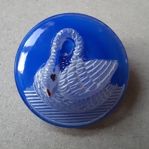 Button swan on blue raised profile handpainted glass. 2.7cm diameter.
