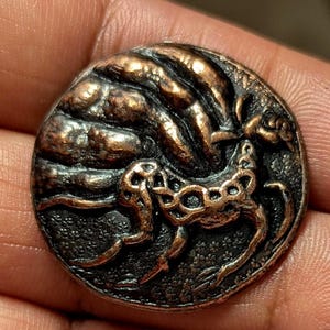 Arts and Crafts style button with galloping horse on landscape. Metal 3cm diameter.