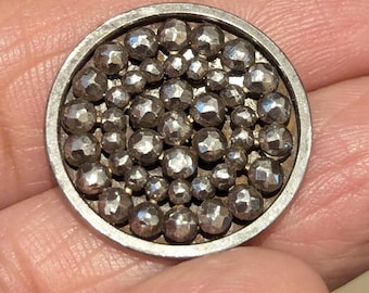 1 1800s button in cut steel. 2 piece button with mirror back. 2cm diameter.