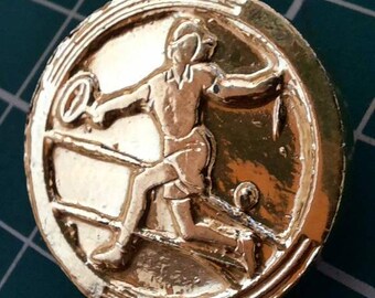 Button womens tennis player by Artid c1947. Gold colour signed. 1 inch diameter.