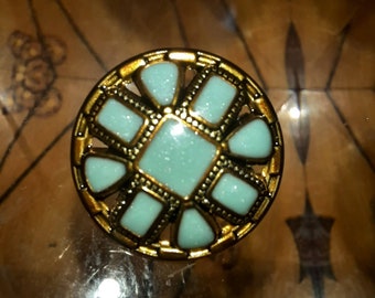 1 Button glass cabachons set in polished brass openwork. Bluey Green or Royal blue. size..1.8cm