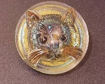 1 button of cat torquoise gold and clear irridescent glass . 25mm diameter.