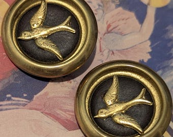 An antique button of a swallow bird in flight. Gilt on leather surround. large 3cm diameter.