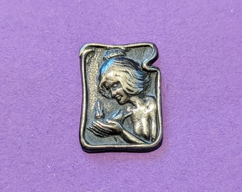C 1902 art nouveau button of girl with bird in hand. 2.7cm long by 1.2cm wide.