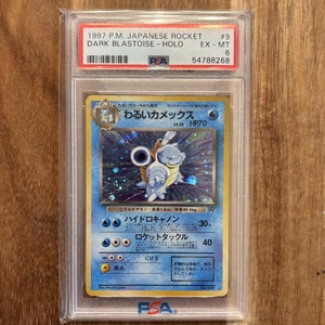 May include: A PSA graded Pokemon card featuring a blue and white Blastoise card with the Japanese text "わるいカメックス" and "LV.28 HP70". The card is graded EX-MT 6.