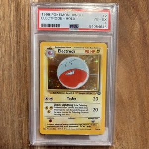May include: A holographic Pokemon trading card featuring Electrode, a Stage 1 Pokemon with 90 HP. The card is from the 1999 Jungle set and is graded VG-EX 4 by PSA.