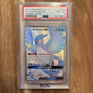 May include: A PSA graded Pokemon card featuring Articuno GX from the Hidden Fates expansion. The card is in near mint condition and has a grade of 8. The card features Articuno GX with a blue and white color scheme and a white background.