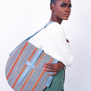 Akoa handcrafted African prints bag Statement wax print bag Stylish work bag Oval shaped handbag Sturdy shoulder bag for women Sky+ Orange Rayure