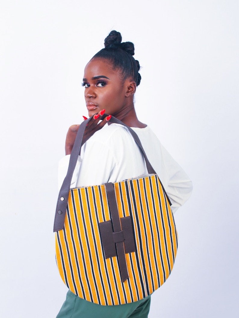 Akoa handcrafted African prints bag Statement wax print bag Stylish work bag Oval shaped handbag Sturdy shoulder bag for women Yellow mustard