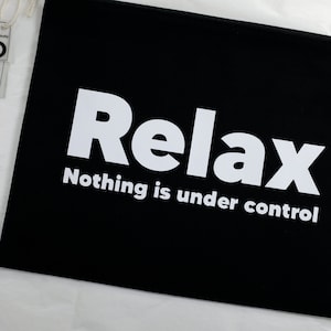 May include: Black zippered pouch with white text that reads "Relax Nothing is under control".