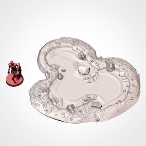 May include: A white, 3D printed miniature terrain piece depicting a small, heart-shaped pond with a rocky edge.
