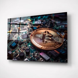 May include: A gold-coloured Bitcoin cryptocurrency coin on a circuit board. The coin has the Bitcoin symbol in the centre.