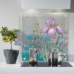 Könnte beinhalten: Eine Küchenszene mit einer Glas-Rückwand mit floralem Design, einem Topf mit Zitronenbaum, einem Edelstahl-Kochtopf und einem Espressokocher. Die Rückwand zeigt eine große lila Iris und andere Wildblumen. Der Zitronenbaum steht in einem dunkelgrauen geometrischen Topf.